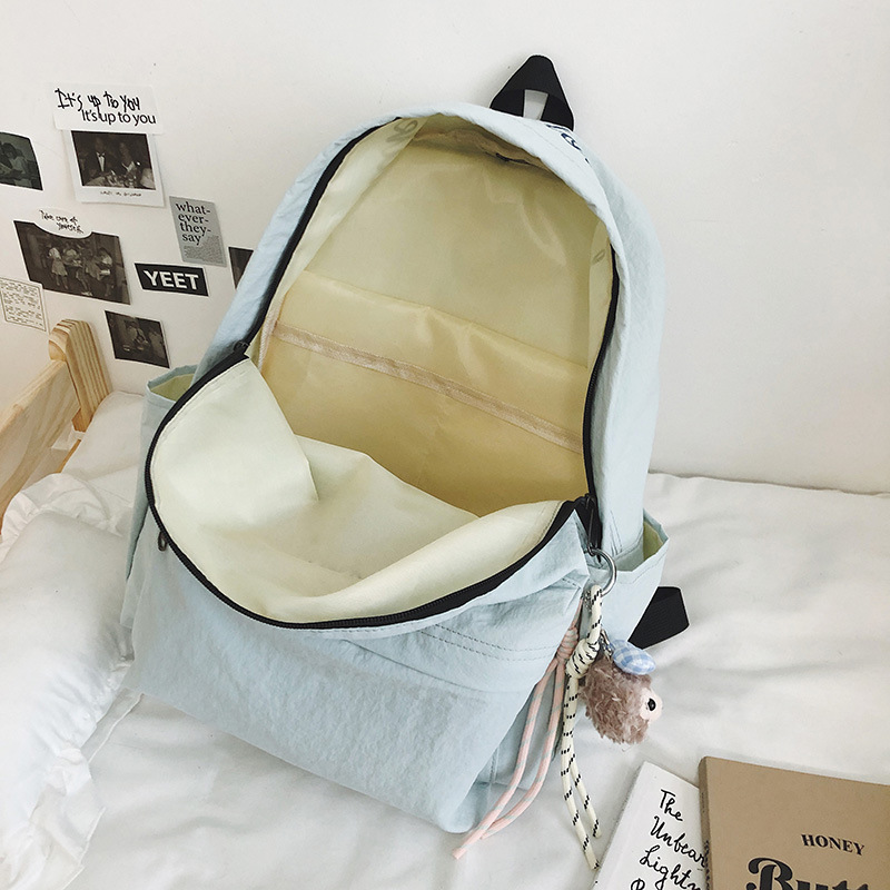 2025 New large-capacity student schoolbag, fashionable smiley face, simple and casual backpack, outdoor travel burden reduction backpack Application Scenario
