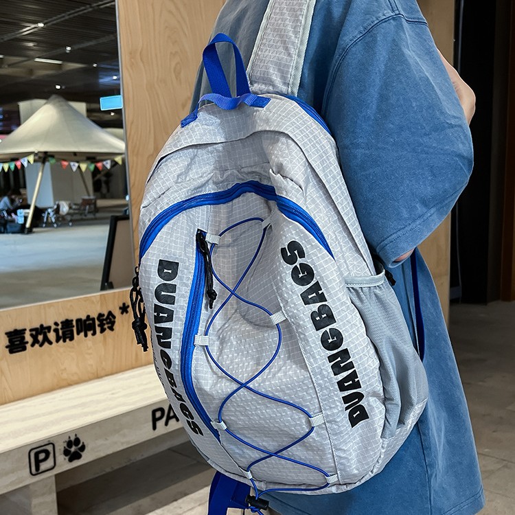 A new high-appeal color-blocking drawstring letter backpack for both men and women, a light and fresh backpack for junior and senior high school students to commute full figure