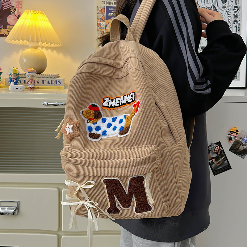 Cartoon dog corduroy girls' schoolbag 2024 New style cute bow backpack, high school and college students' backpack details Picture