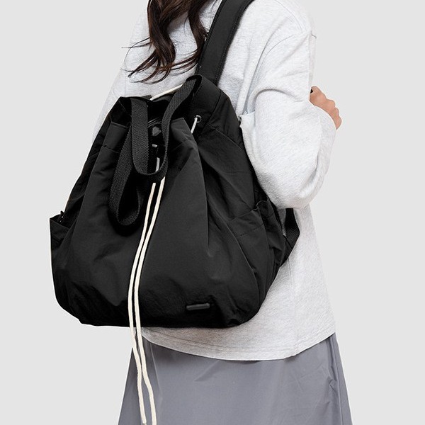 A new and fashionable Korean-style women's niche drawstring backpack with a large capacity and lightweight nylon commuting hand bag full figure