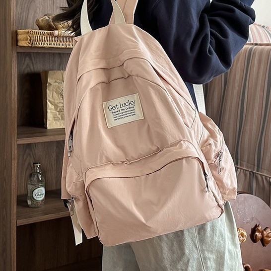 New large-capacity student schoolbag, solid color casual outdoor versatile backpack, water-washed fabric simple school style bag Application Scenario