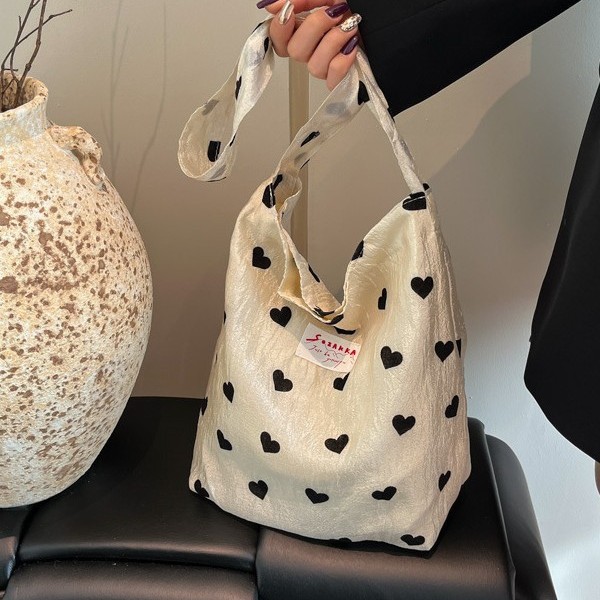 A new style of heart-shaped canvas single-shoulder bag for girls, a large-capacity handbag, a makeup bag and a student underarm bag Application Scenario