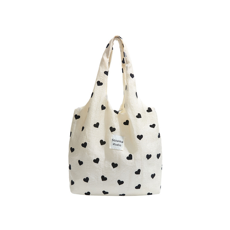 A new style of heart-shaped canvas single-shoulder bag for girls, a large-capacity handbag, a makeup bag and a student underarm bag Item Picture