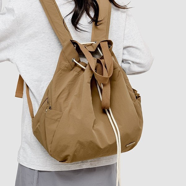 A new and fashionable Korean-style women's niche drawstring backpack with a large capacity and lightweight nylon commuting hand bag details Picture