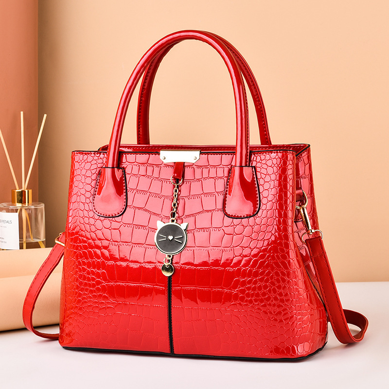The 2021 new shiny leather women's bag with a European and American style, featuring a simple stone pattern, is a large hand-held shoulder crossbody bag details Picture