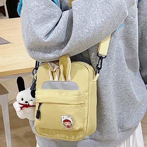 A new Korean-style cute rabbit-ear backpack for primary school students, suitable for both men and women, and a Japanese-style cute crossbody bag for young girls full figure