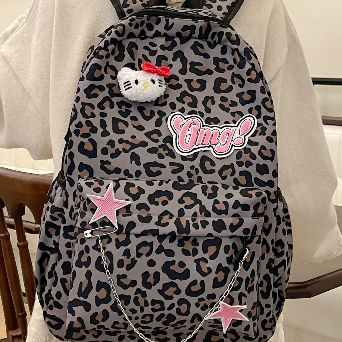 The new cartoon girl leopard print backpack is cute and has a large capacity. It is a versatile and fashionable backpack for students full figure
