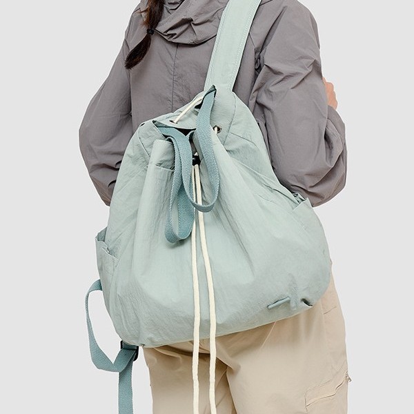 A new and fashionable Korean-style women's niche drawstring backpack with a large capacity and lightweight nylon commuting hand bag Application Scenario