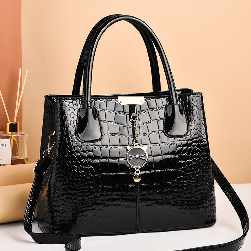 The 2021 new shiny leather women's bag with a European and American style, featuring a simple stone pattern, is a large hand-held shoulder crossbody bag full figure