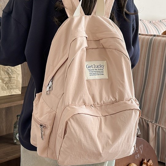 New large-capacity student schoolbag, solid color casual outdoor versatile backpack, water-washed fabric simple school style bag details Picture
