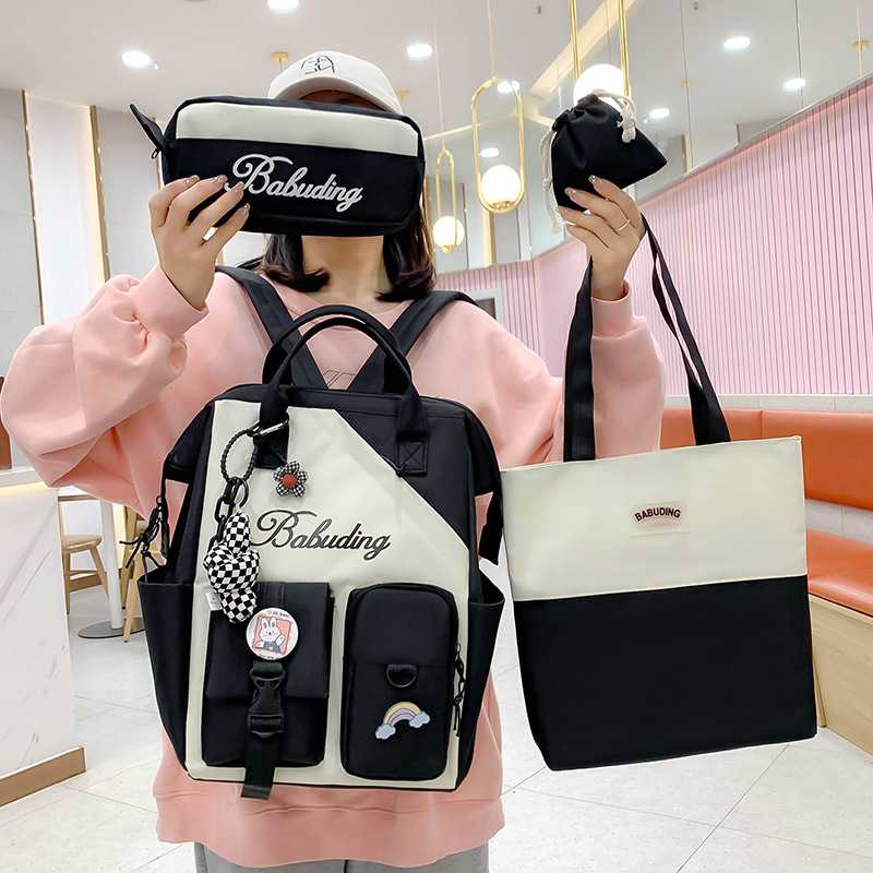 Wholesale of new and cute Japanese single-shoulder backpacks for junior and senior high school students. Four-piece student schoolbag set full figure