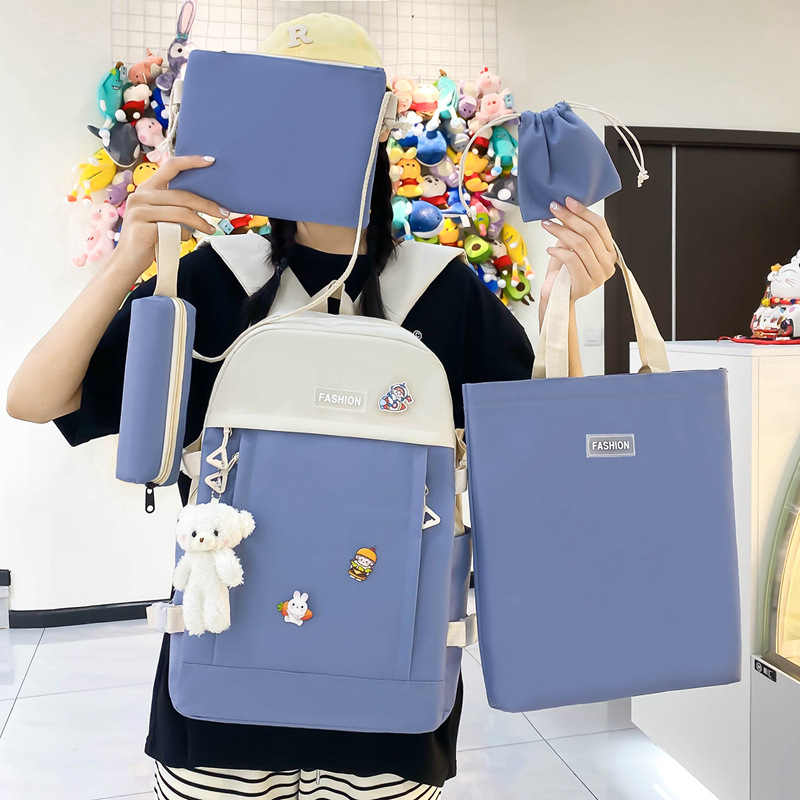 The new canvas campus backpack five-piece set is simple and versatile. It is a multi-functional casual girls' backpack for junior and senior high school students full figure