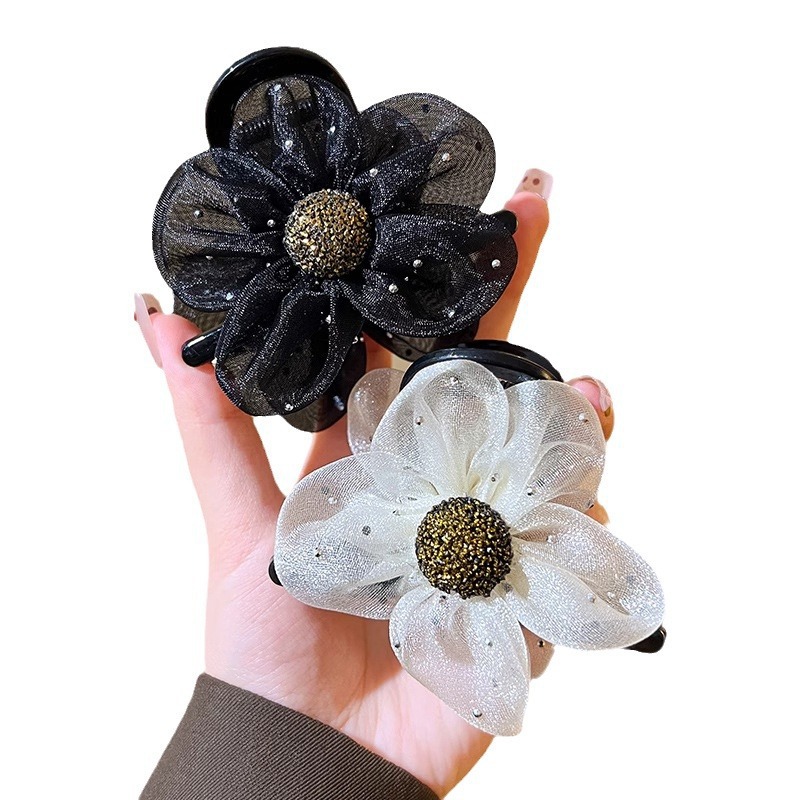A fashionable and simple women's updo with a netted diamond sunflower clip, a shark clip at the back of the head, and a high-end flower hair clip Item Picture