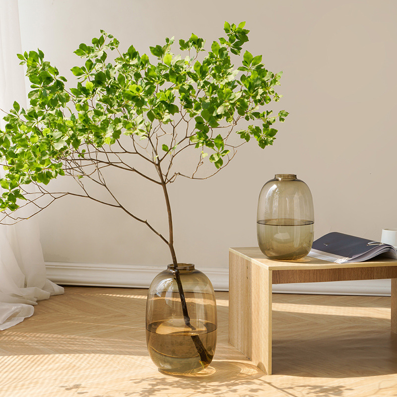 A transparent glass vase for living room flower arrangement, with a high-end look and a high level of appearance. A special fresh flower hanging clock for hydroponic snow willow and magnolia details Picture