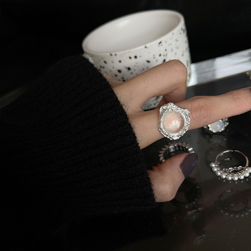 A small diamond, exaggerated gemstone, crystal, irregular-shaped, high-end, niche design ring with a cold style, a woman opens her mouth Application Scenario