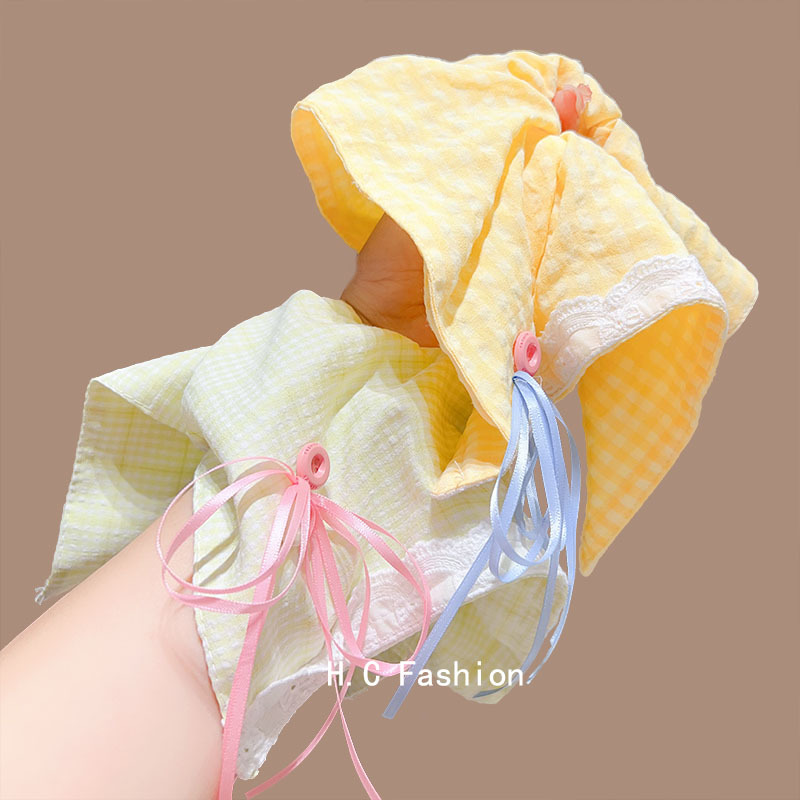 A Korean girl's large yellow checkered button bow square scarf large intestine circle shows off her face. She has a small ponytail hair band Application Scenario