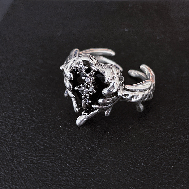 A black zircon ring with a cold and unique style for women on Instagram. It features a dark heart-shaped texture with an open design, which is a light luxury and niche design details Picture