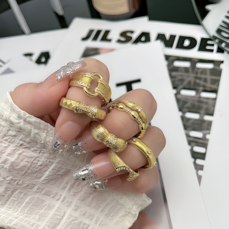 A unique, exquisite and light luxury ring with a unique design of a women's niche market featuring golden wheat ear weaving and brushed geometric openings Application Scenario