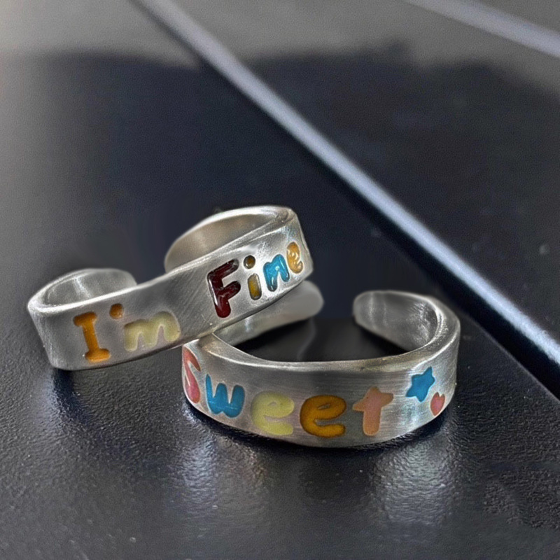 The Japanese and Korean rainbow drip glaze letter open ring is a niche design for women, with a retro, individual and high-end feel. It's a cold style ring trend full figure