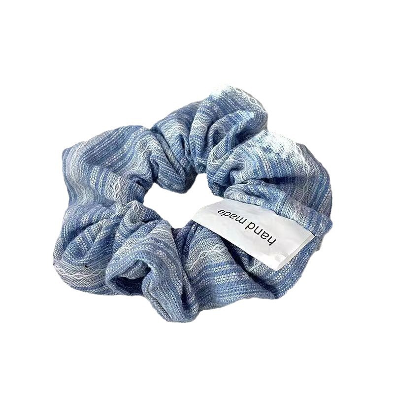 The gentle striped large intestine hair band exudes a high-end feminine charm. The loose, plain Korean-style bun hair band is elegant and refined Item Picture