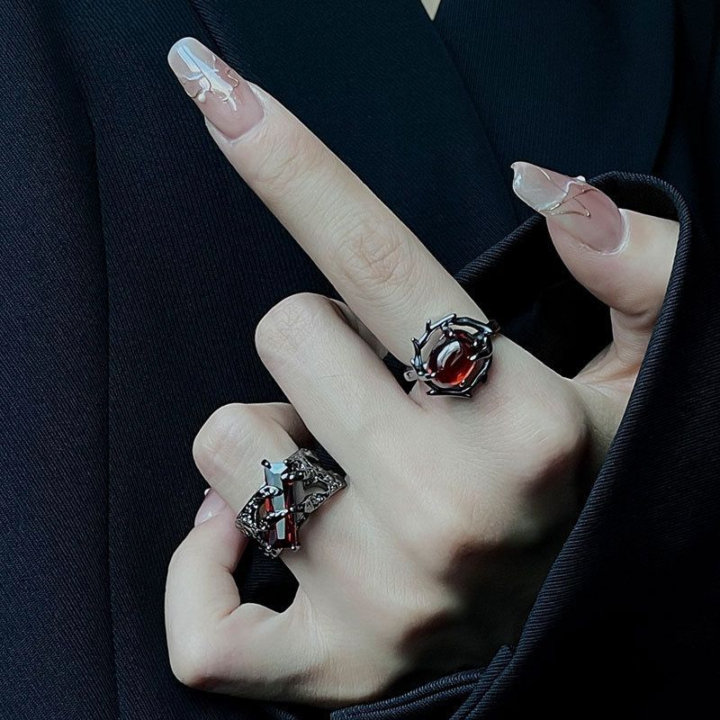 The hollowed-out retro garnet red geometric design ring is a trendy and individualistic dark European and American cold style open ring full figure
