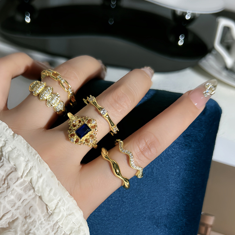 A trendy, slightly inlaid blue diamond lace open ring in the style of ancient Chinese coins, a simple and individual cold style index finger ring for women full figure