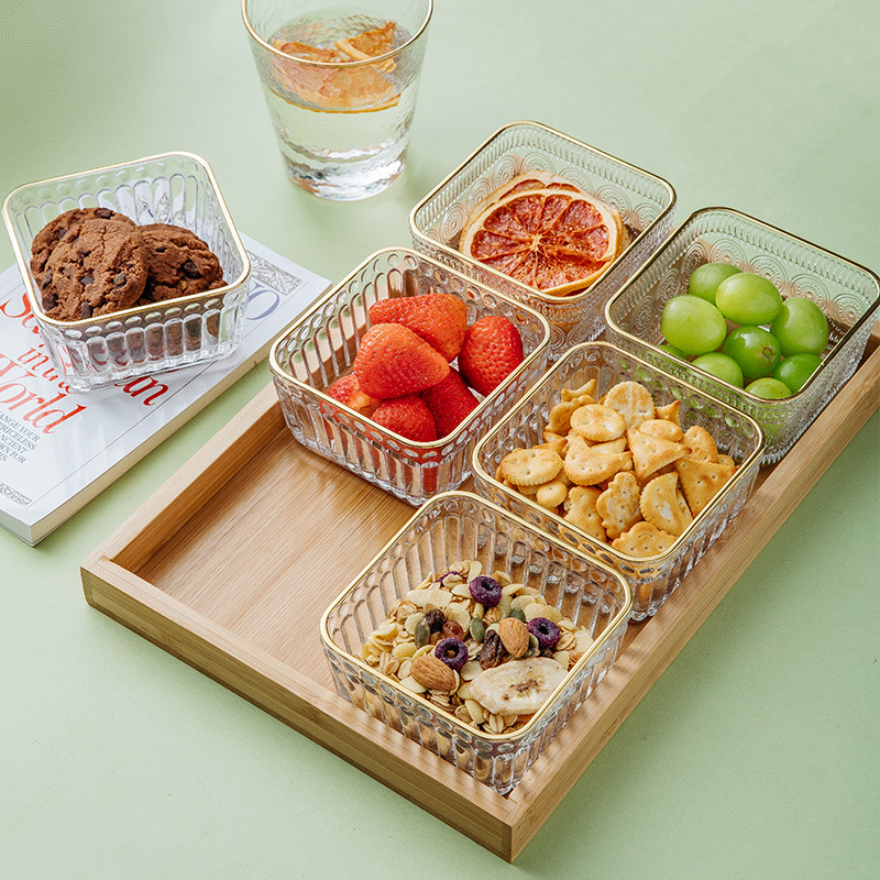 A glass compartments fruit plate for roasting tea around a stove, a modern living room snack plate, a home snack, candy, dried fruit and dim sum platter Application Scenario