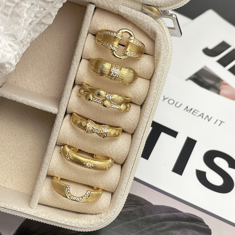 A unique, exquisite and light luxury ring with a unique design of a women's niche market featuring golden wheat ear weaving and brushed geometric openings full figure
