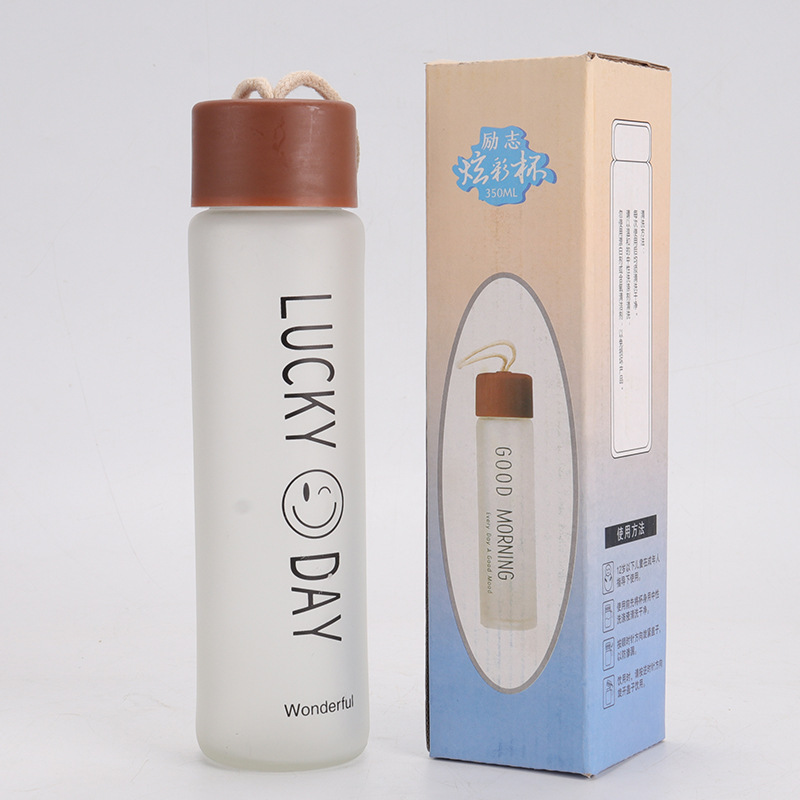 The frosted glass water cup with a drawstring is a simple forest-style cup that can be carried with a drawstring for creative outdoor sports full figure
