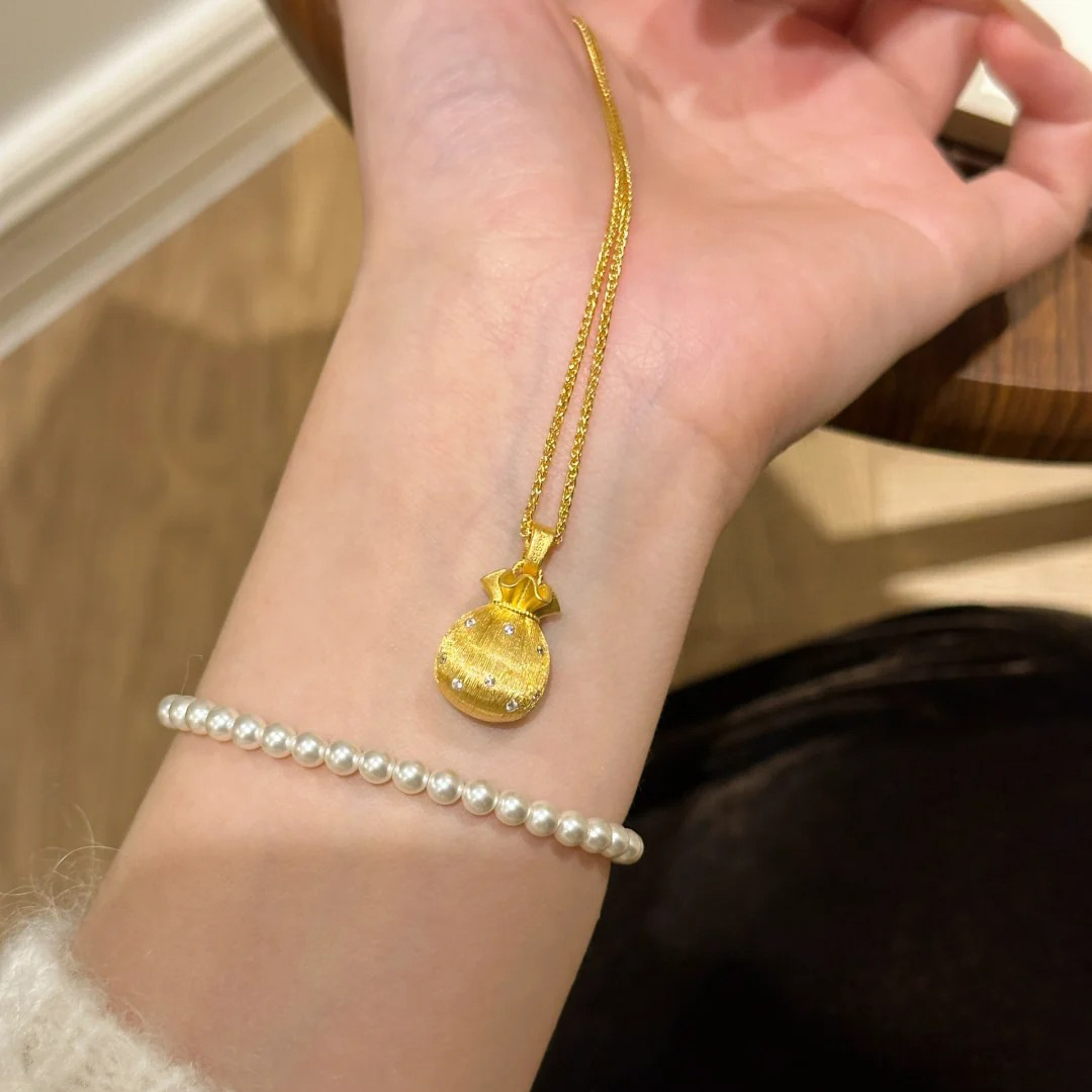 A golden brushed small lucky bag necklace full of good fortune, a new Chinese-style light luxury versatile titanium steel collarbone chain that doesn't fade details Picture