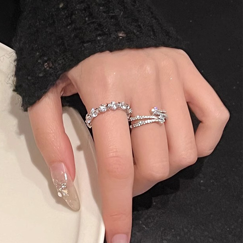This is a niche design with a fashionable and elegant style. It features a double-layered star-encircled open ring with a cold and delicate diamond-encrusted five-pointed star ring details Picture