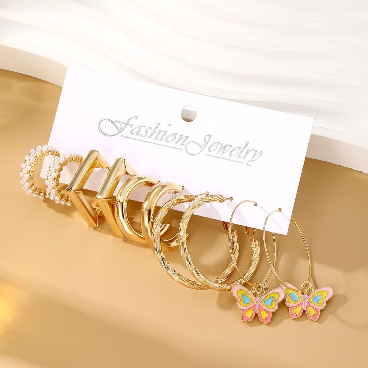 A new set of fresh and sweet pearl-inlaid metal earrings featuring oil-dripping C-shaped butterfly pendant ear hooks from Europe and America Application Scenario