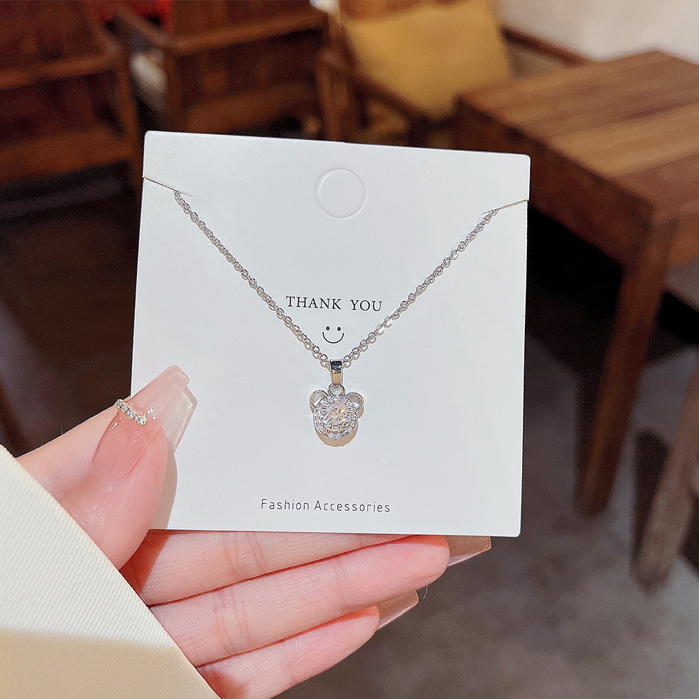 A simple titanium steel necklace with a light luxury and niche design for women. It features a collarbone chain and a zircon bear head pendant as a birthday gift details Picture