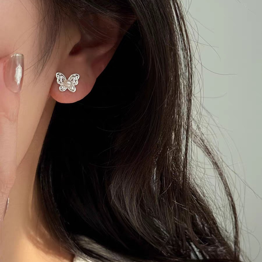 Korean-style hollowed-out butterfly pearl earrings on Instagram, a niche, sweet, exquisite and elegant style. New earrings for women with ear bone studs in 2025 details Picture