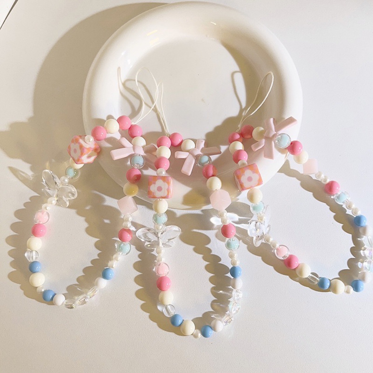 Bow pink Magic cube flower mobile phone chain for women, ins style, fashionable and fresh wrist pendant, handcrafted beaded chain details Picture