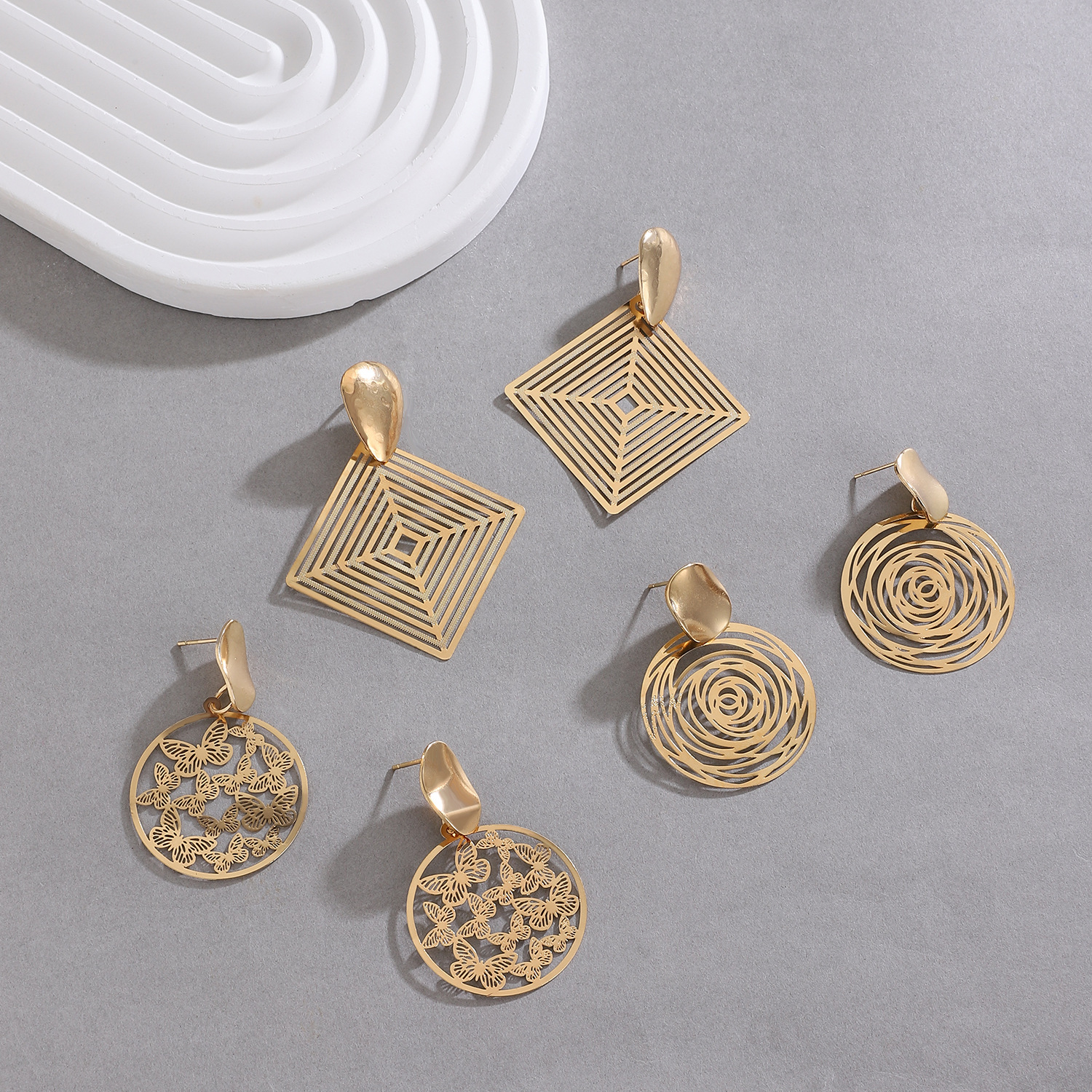 Cross-border hollowed-out butterfly geometric earrings, women's ins style, exaggerated European and American temperament, alloy round and square stud earrings Application Scenario