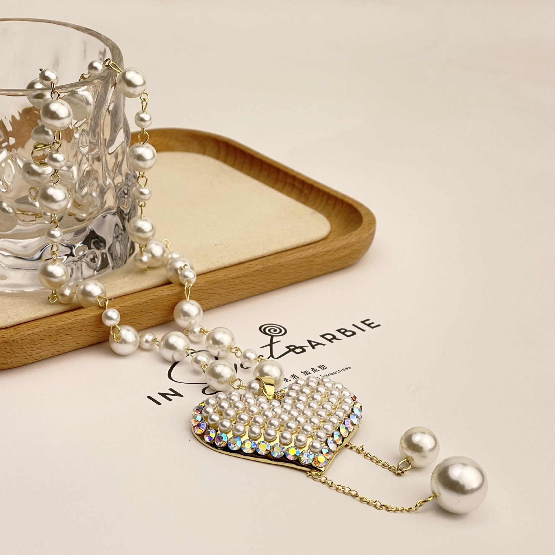 Wholesale of new tassel pearl heart-shaped necklace with a fashionable and individualistic touch, long pearl sweater chain pendant details Picture