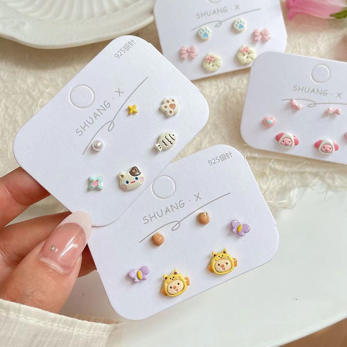 A three-piece set of Korean-style, cute and cartoonish ear studs. It's a unique and versatile summer ear accessory with a touch of childlike fun full figure