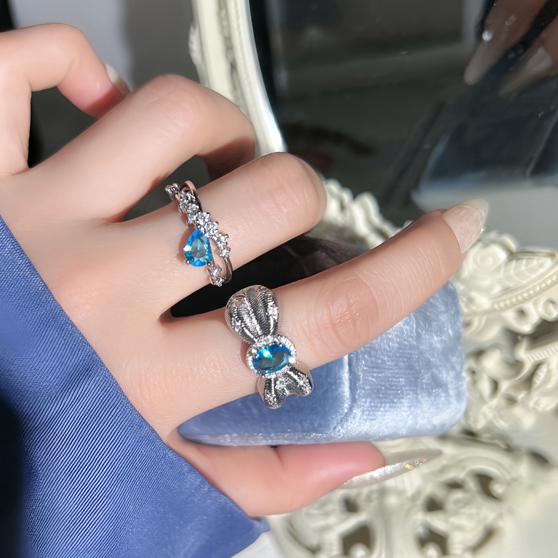 Super Flash Heavy Industry Water Drop Sea Blue Diamond Pigeon Egg inlaid open ring, feminine, niche bow light luxury ring full figure