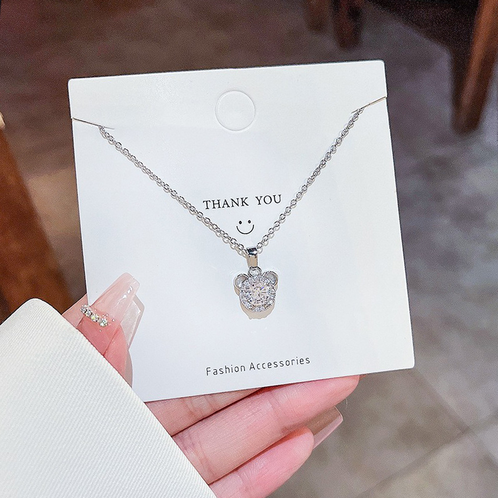 A simple titanium steel necklace with a light luxury and niche design for women. It features a collarbone chain and a zircon bear head pendant as a birthday gift full figure