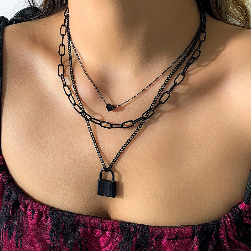 A sweet and cool geometric heart-shaped lock-shaped necklace with a dark punk style from Europe and America, featuring a black cross-chain layering necklace full figure