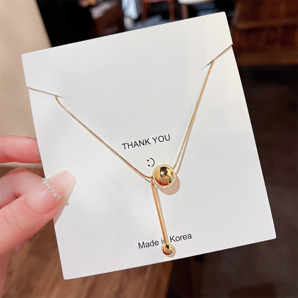 Wholesale of 18K small gold ball tassel necklaces from Japan and South Korea for women. Simple love bean titanium steel collarbone chain design necklace accessory details Picture