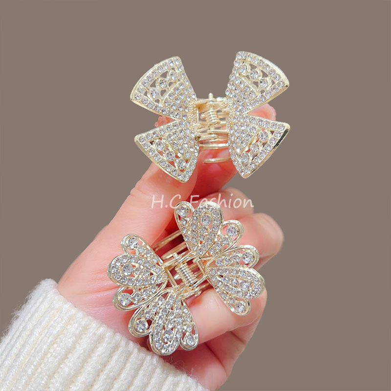 A new elegant hairpin accessory featuring a high-end water diamond butterfly claw clip, a delicate half-tied updo shark clip at the back of a woman's head Application Scenario