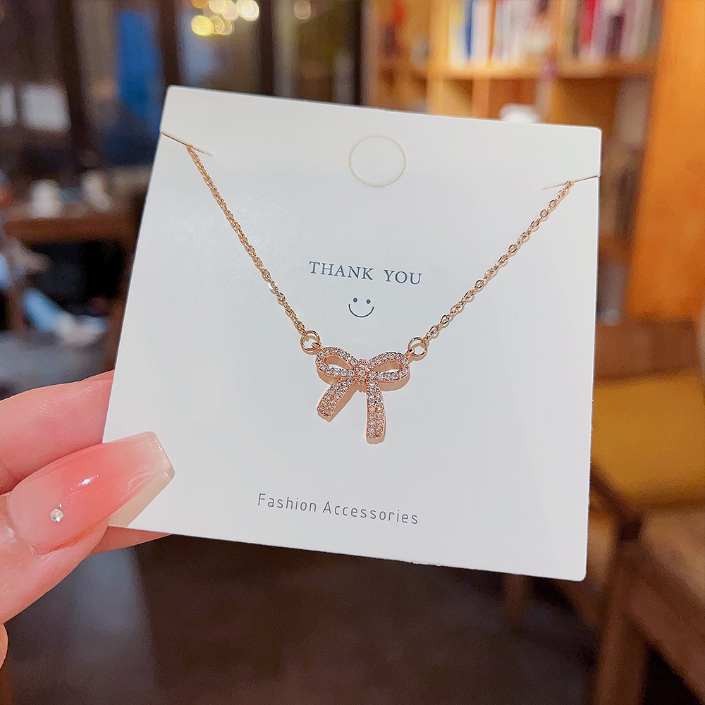 Sweet and cool hot girl micro-inlay bow pendant titanium steel necklace, female Internet celebrity's unique design sense and temperament collarbone chain wholesale details Picture