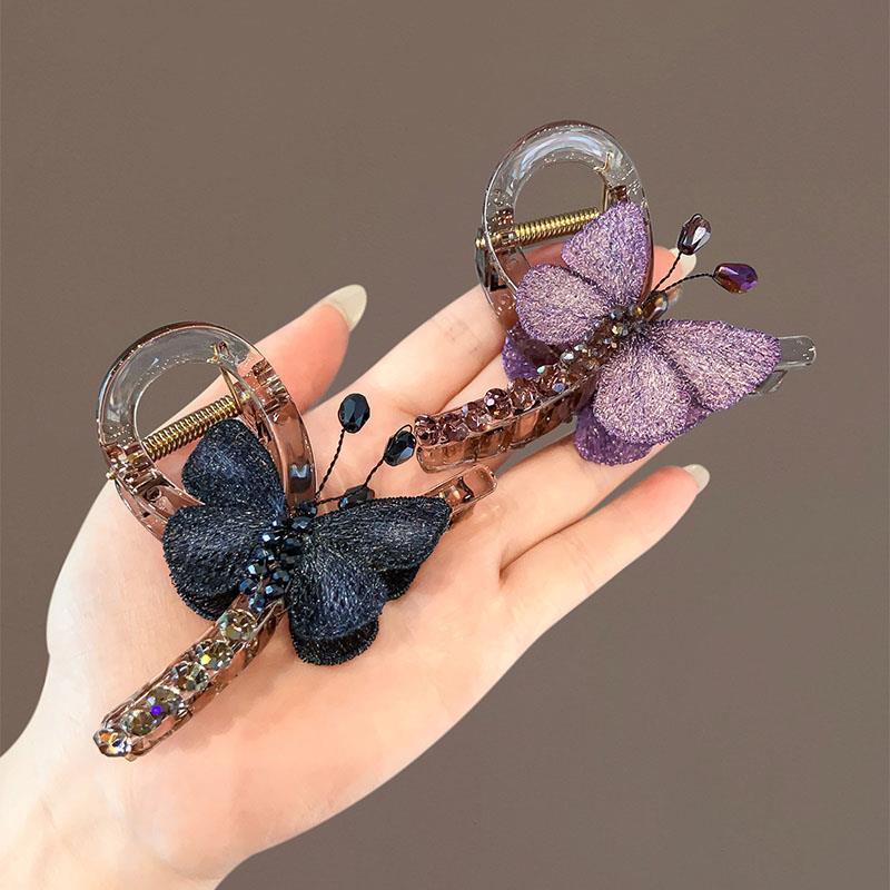 "Fall for the Butterfly ~ A retro style embroidered butterfly grab clip for a medium-sized woman with a half-tied hair at the back of her head and a shark clip hair accessory. Application Scenario