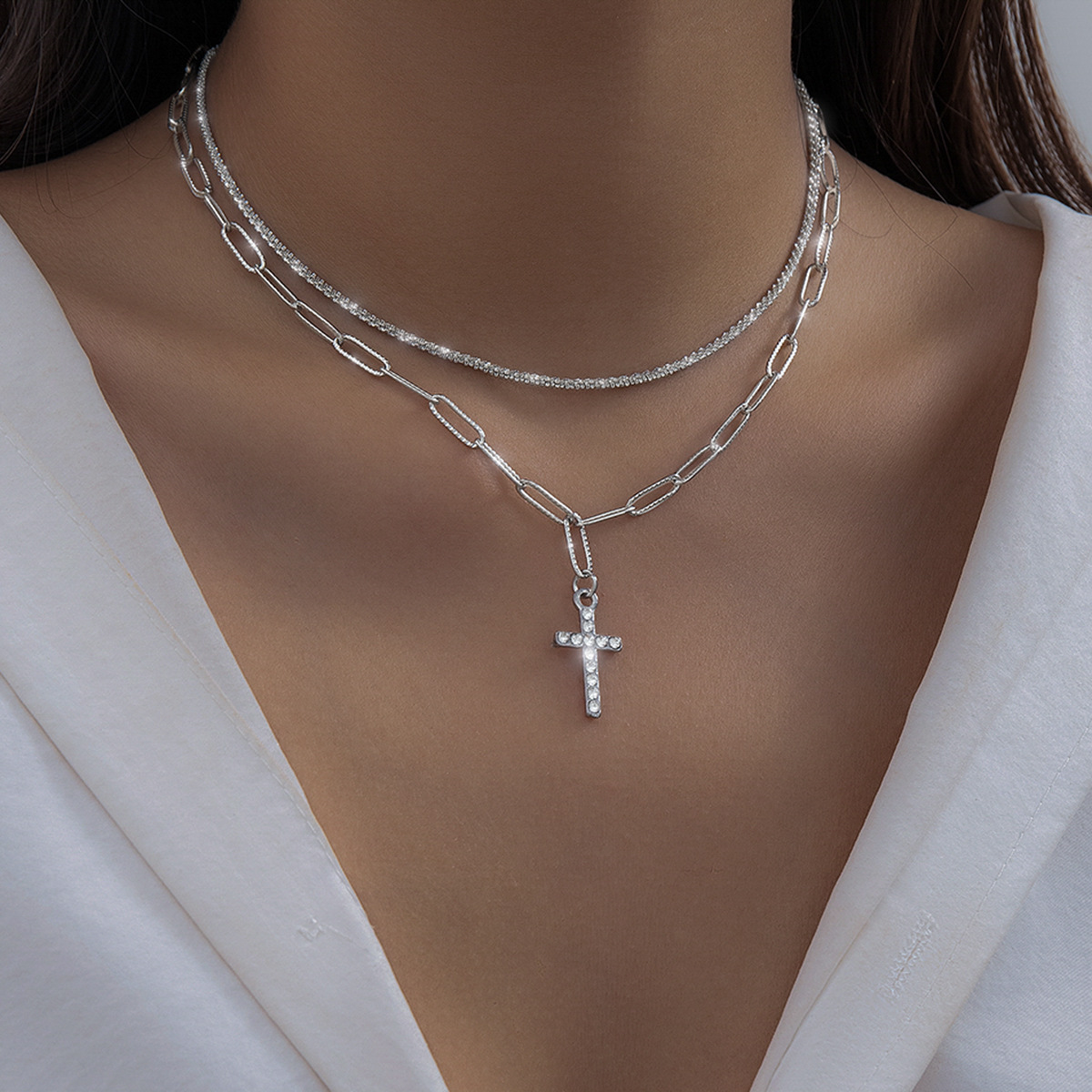 A versatile, sparkling chain collarbone necklace for women with tassels and diamond-encrusted crosses full figure