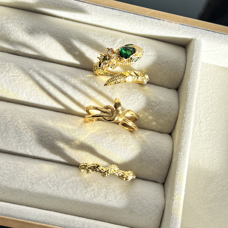 A green diamond snake-shaped brushed opening ring in the style of Chinese fashion for women, a delicate and versatile index finger ring wrapped around the zodiac year's spirit snake full figure