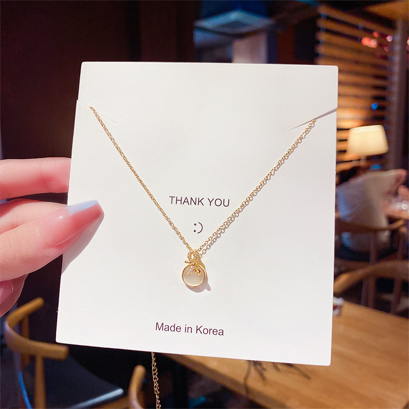 Korean internet-famous bow necklace for women, a simple and trendy titanium steel brand with a unique design sense. Wholesale of cat's eye stone collarbone chain full figure