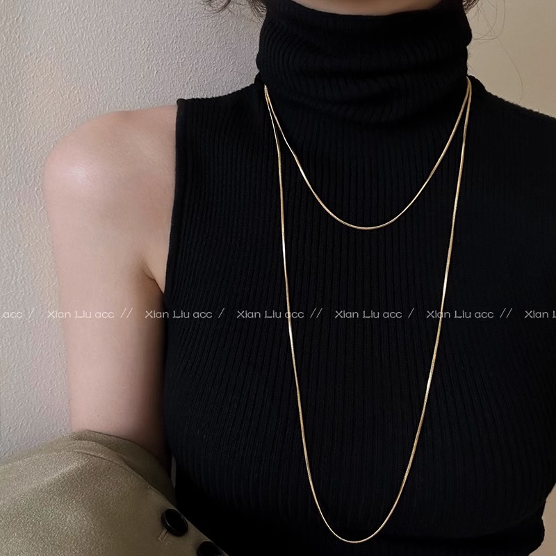 A long, layered golden snake bone chain and plain chain necklace with a simple and elegant style. It's a trendy and versatile sweater chain for women full figure