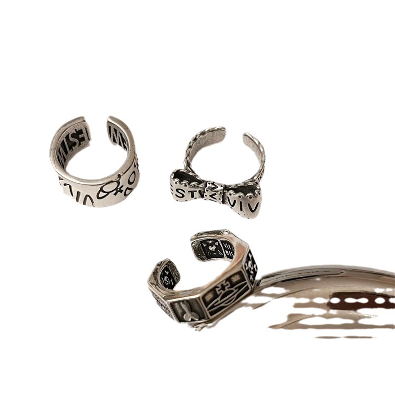 A Western post-punk cold style vintage Saturn mid-style bow skull wide letter ring for a woman Item Picture